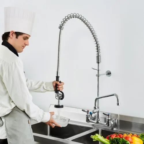 Chef using commercial kitchen sink sprayer nozzle.